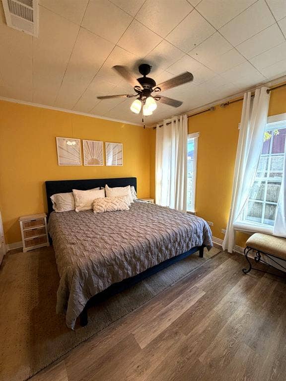 201 S Jones Street, Granbury, TX 76048 Wood-finish flooring, paneled ceiling, and ceiling fan with integrated light fixture
