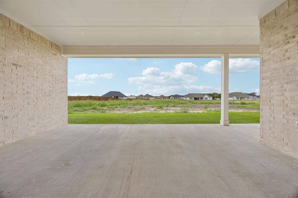 108 Swan Lake Drive, Waxahachie, TX 75165 Covered patio featuring concrete flooring, brick exterior walls, and a recessed ceiling with integrated lighting