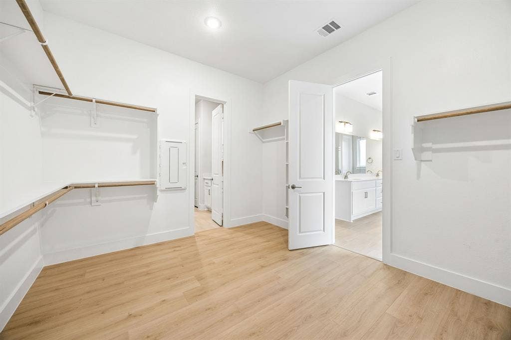 108 Swan Lake Drive, Waxahachie, TX 75165 Walk-in storage space featuring wood-finish flooring, multi-tier shelving, recessed lighting, and a six-panel door