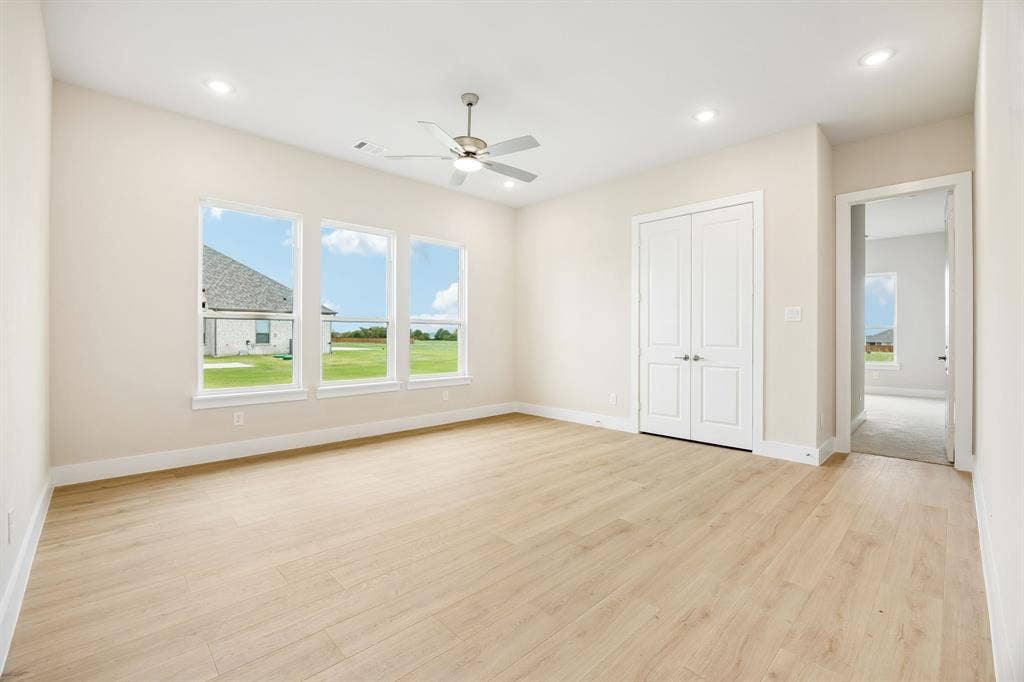 108 Swan Lake Drive, Waxahachie, TX 75165 Neutral interior space featuring wood-finish flooring, recessed lighting, a ceiling fan, and double-panel doors