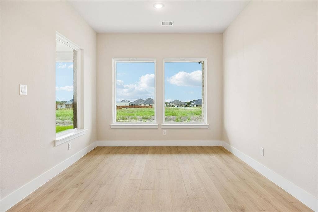 108 Swan Lake Drive, Waxahachie, TX 75165 Room featuring wood-finish flooring, recessed lighting, and multiple windows providing natural light