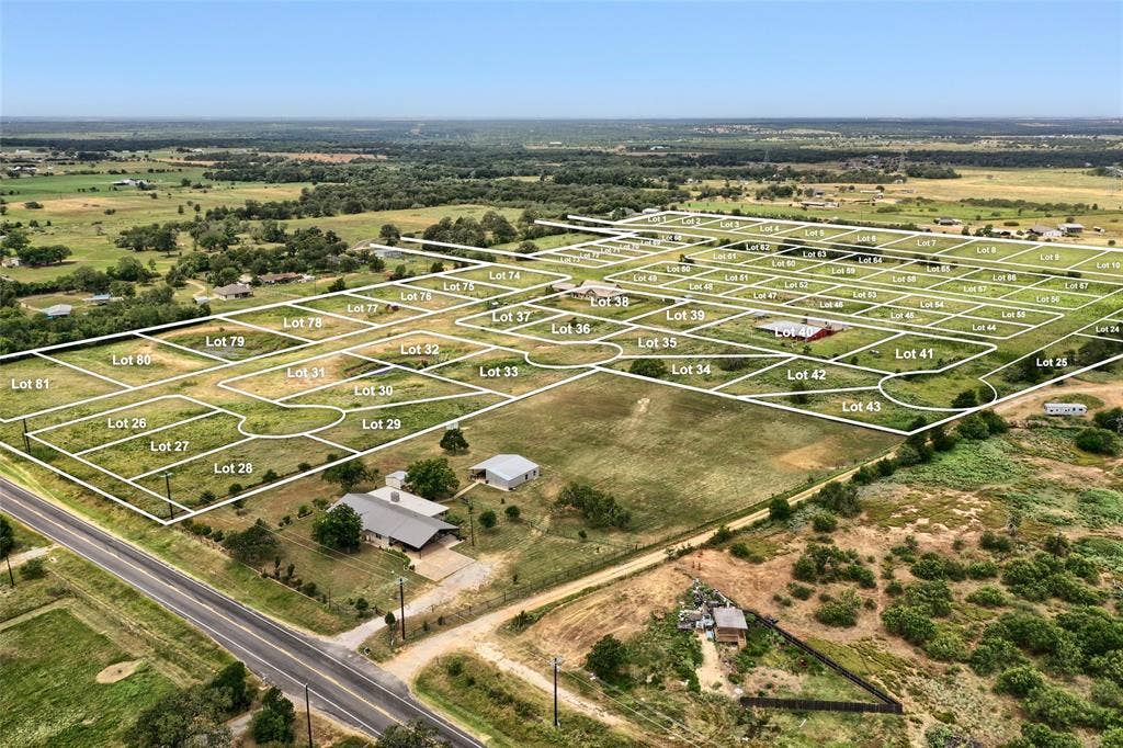 Lot 40 Prado Vista, Elgin, TX 78621 Aerial perspective of expansive acreage featuring partitioned residential lots, established infrastructure, and proximity to paved public roadways