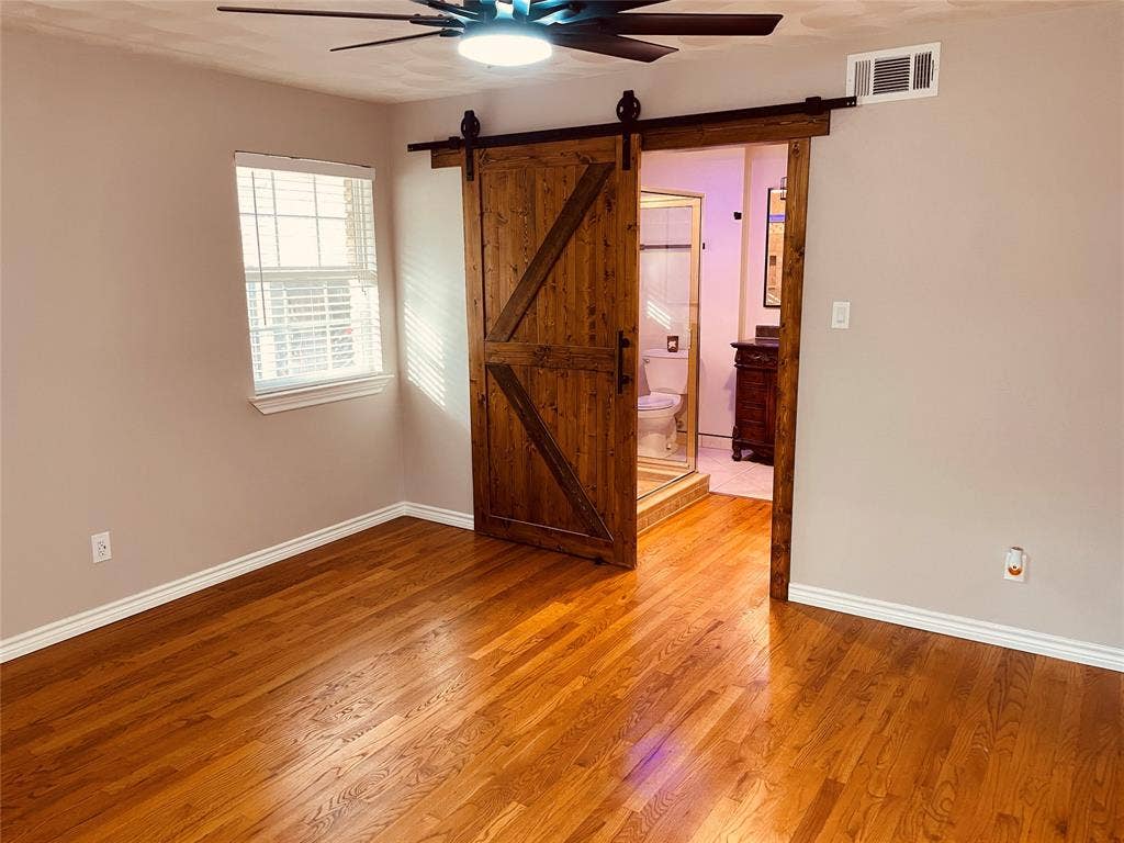 530 E Spring Valley Road, Richardson, TX 75081 Master Bedroom, looking into the Master Bathroom through the new barn door