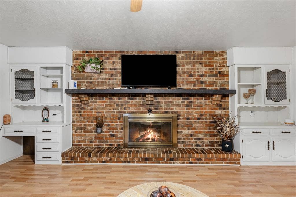 Great storage is on each side of the fireplace.