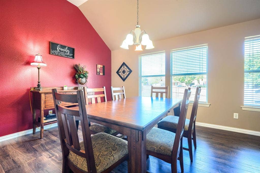 Vaulted ceilings, wood-finish flooring, and natural light from triple windows