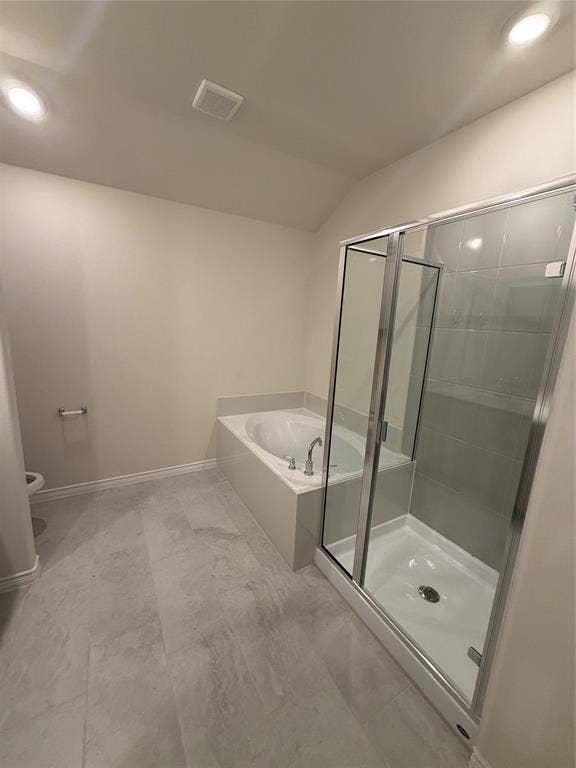 Bathroom featuring a deep soaking tub with a deck surround, a separate glass-enclosed shower, large-format tile flooring, and recessed ceiling lighting
