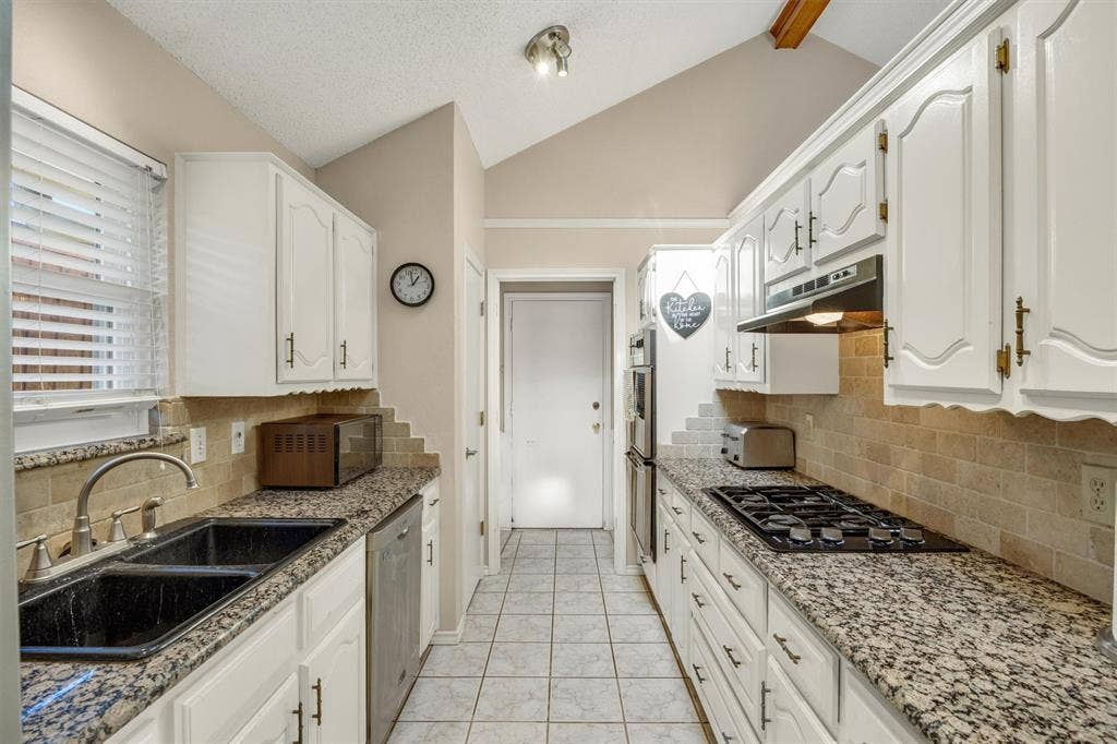 1025 Brownfield Drive, Mesquite, TX 75150 Kitchen featuring white cabinetry, granite countertops, stone-tile backsplash, stainless steel built-in oven, and a gas cooktop