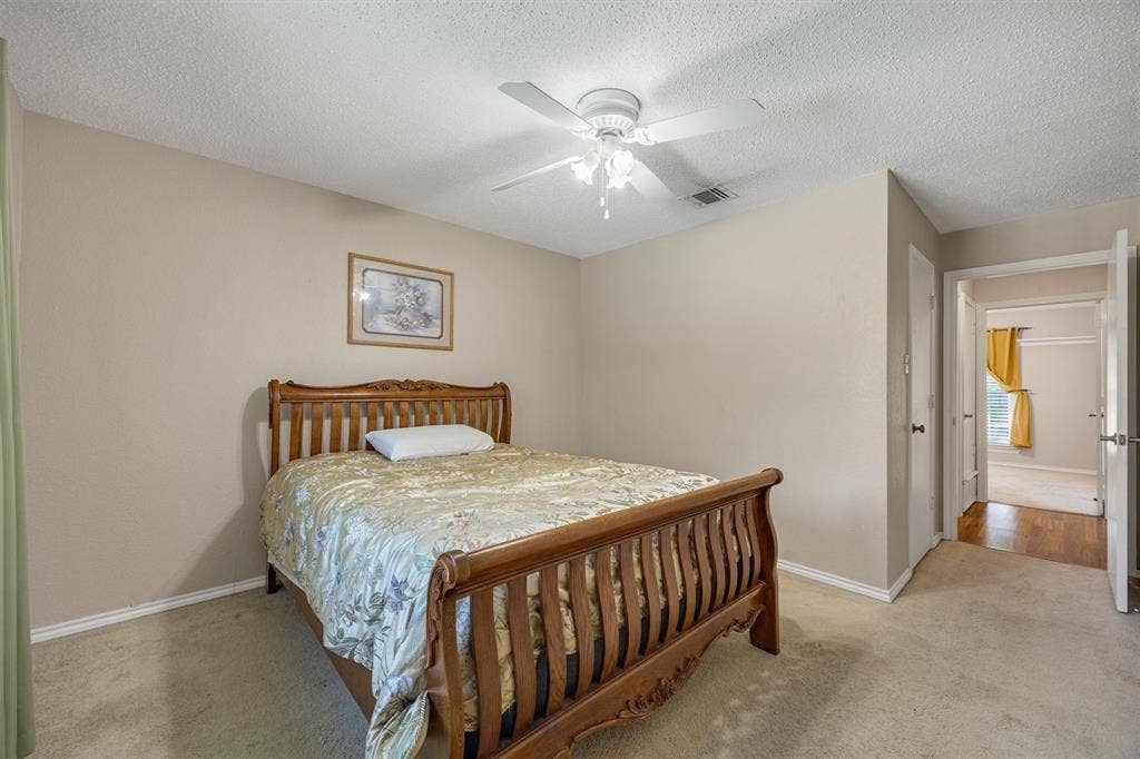 1025 Brownfield Drive, Mesquite, TX 75150 Room featuring neutral wall tones, carpeted flooring, and a ceiling-mounted light fixture with an integrated fan