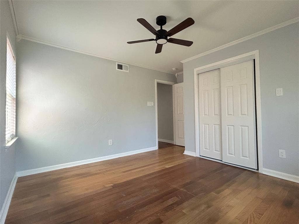 3136 Chatsworth Drive, Farmers Branch, TX 75234 Room featuring wood-finish flooring, a ceiling fan with integrated lighting, and a closet with white paneled sliding doors