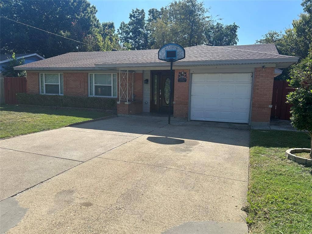 3136 Chatsworth Drive, Farmers Branch, TX 75234 Single-story brick exterior featuring a shingled roof, an attached garage, and a concrete driveway