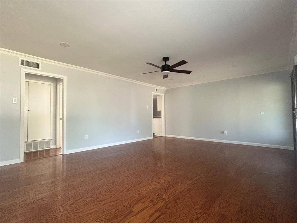 3136 Chatsworth Drive, Farmers Branch, TX 75234 Spacious interior featuring wood-finish flooring, recessed lighting, and a dark-finish ceiling fan