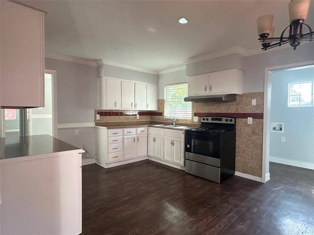 3136 Chatsworth Drive, Farmers Branch, TX 75234 Kitchen featuring white cabinetry, wood-finish flooring, a stainless steel range, a dual-basin sink, and a decorative tile backsplash