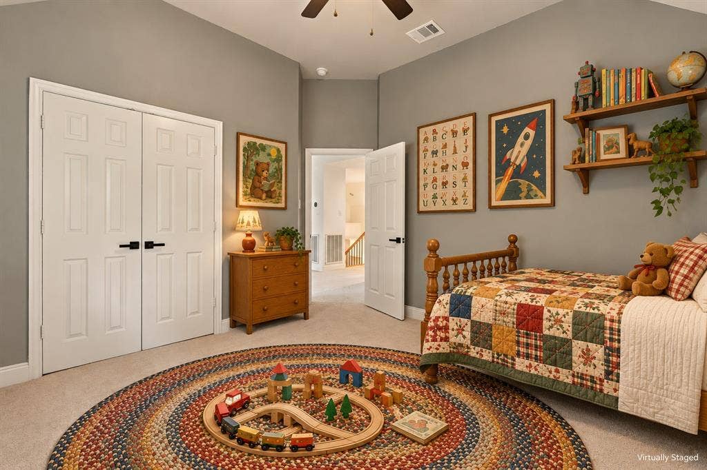 511 Clover Leaf Lane, McKinney, TX 75072 Vaulted ceilings, neutral wall color, carpeted flooring, double-door closet with matte black hardware, and an attached ceiling fan