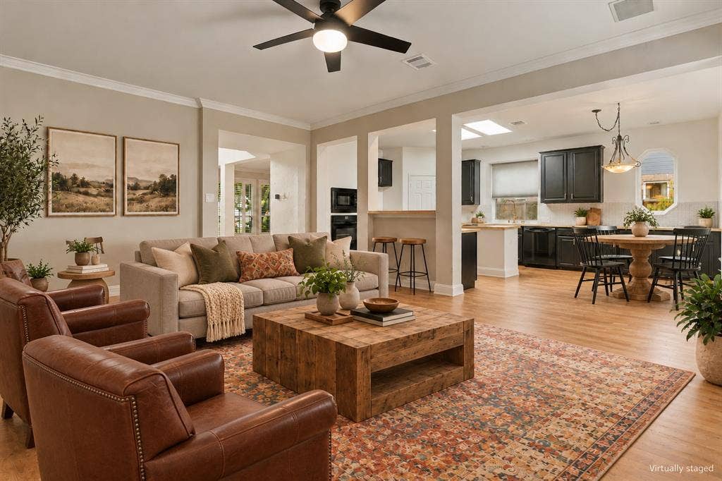 511 Clover Leaf Lane, McKinney, TX 75072 Open-concept interior featuring wood-finish flooring, recessed lighting, a modern ceiling fan, crown molding, and skylights