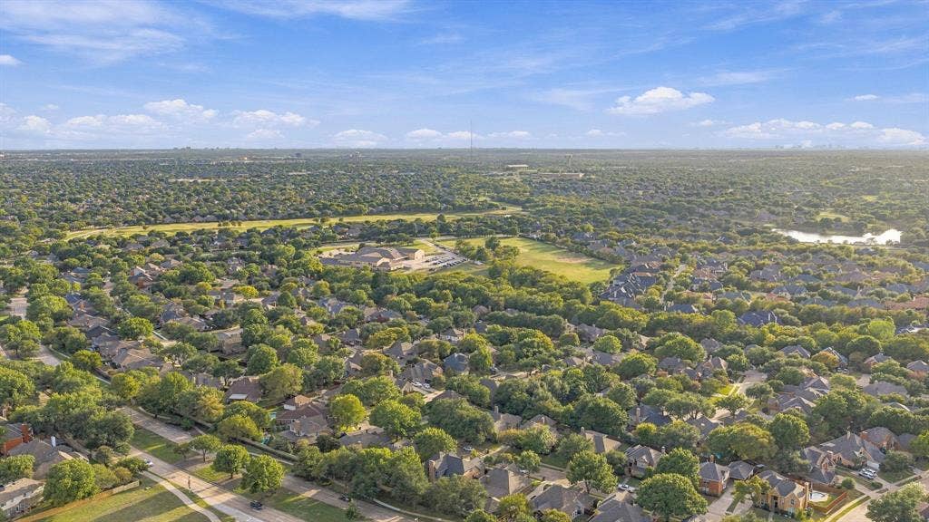 511 Clover Leaf Lane, McKinney, TX 75072 Aerial perspective featuring mature tree canopies, expansive green space, and residential surroundings