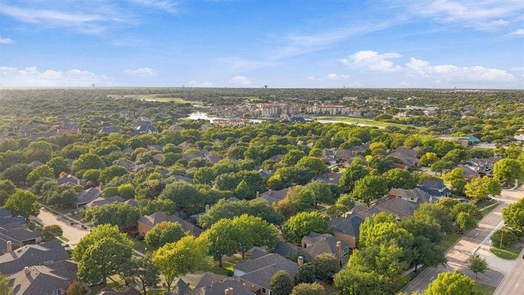 511 Clover Leaf Lane, McKinney, TX 75072 Aerial perspective of a residential neighborhood characterized by dense mature tree coverage and established landscaping