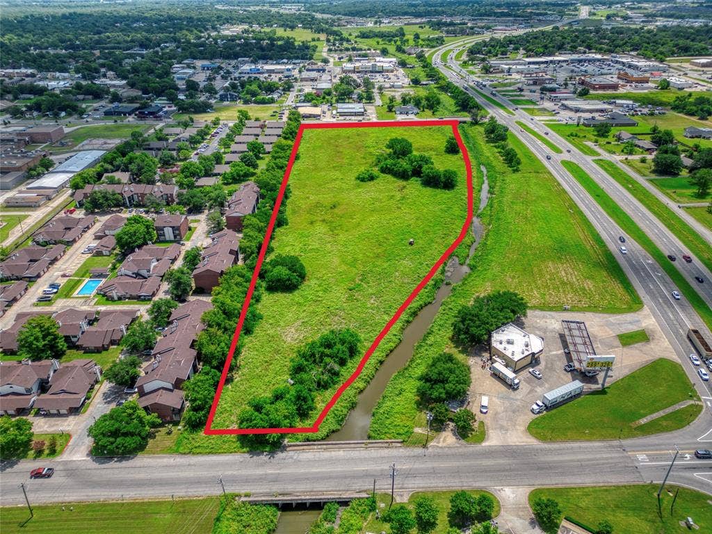 0000 King Street, Greenville, TX 75401 Undeveloped land parcel featuring expansive open terrain, mature trees, and frontage along a natural water feature