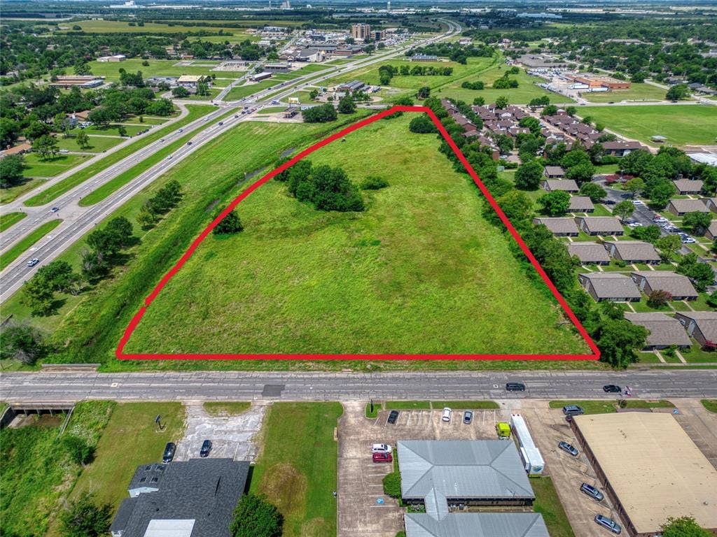 0000 King Street, Greenville, TX 75401 Expansive parcel of land featuring open green space, mature trees, and direct roadway access