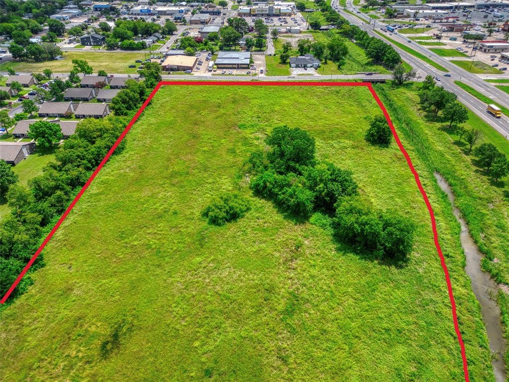 0000 King Street, Greenville, TX 75401 Expansive, open-lot land parcel featuring established mature trees and natural topography
