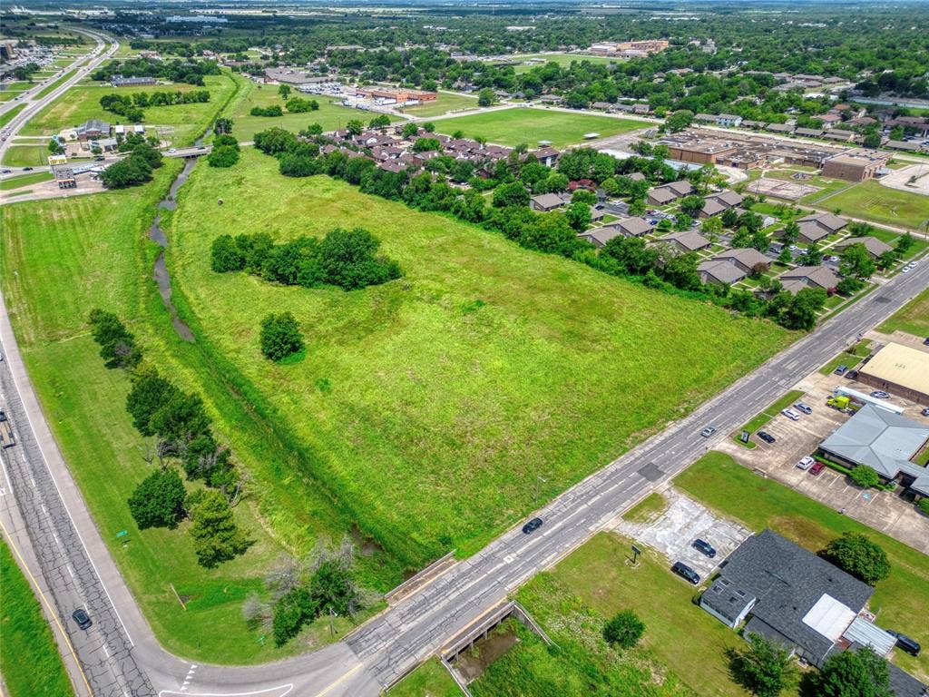 0000 King Street, Greenville, TX 75401 Expansive undeveloped acreage featuring cleared terrain, mature trees, and natural drainage topography with direct frontage to paved thoroughfares