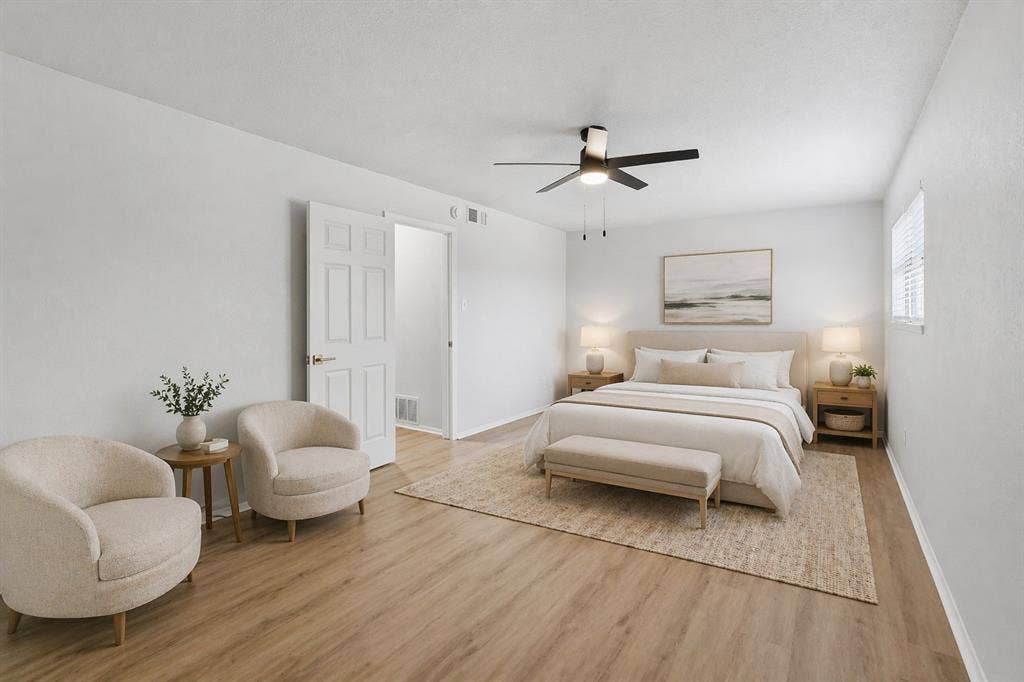5514 Round Rock Road, Garland, TX 75044 Spacious interior featuring wood-finish flooring, a ceiling fan with integrated lighting, and a six-panel interior door