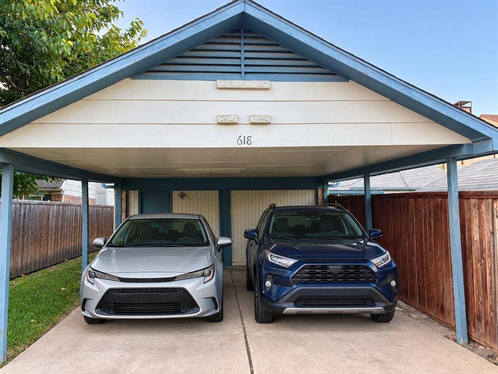 618 Pyramid Drive, Garland, TX 75040 Covered two-car carport featuring a gabled roofline, slatted ventilation detail, and a concrete parking surface