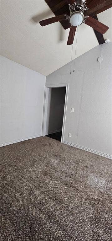 Vaulted ceiling featuring a dark wood-finish ceiling fan with integrated lighting and wall-to-wall carpeting