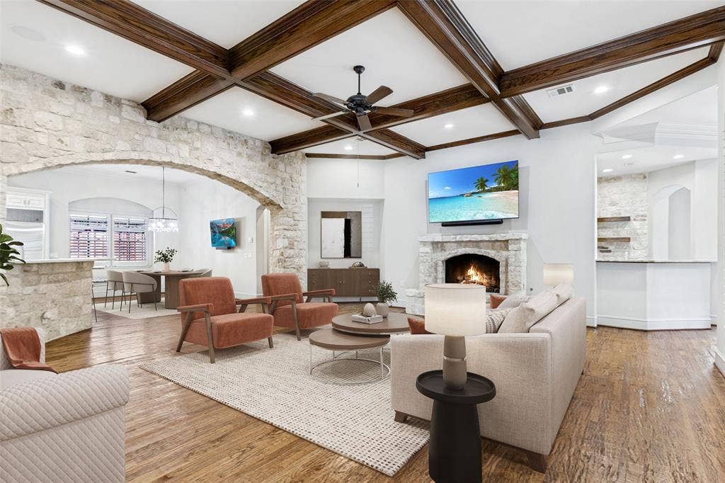 6467 Orchid Lane, Dallas, TX 75230 Another view of the Family Room showing the coffered ceiling, fireplace, stone architectural accents, and wet bar to the right.