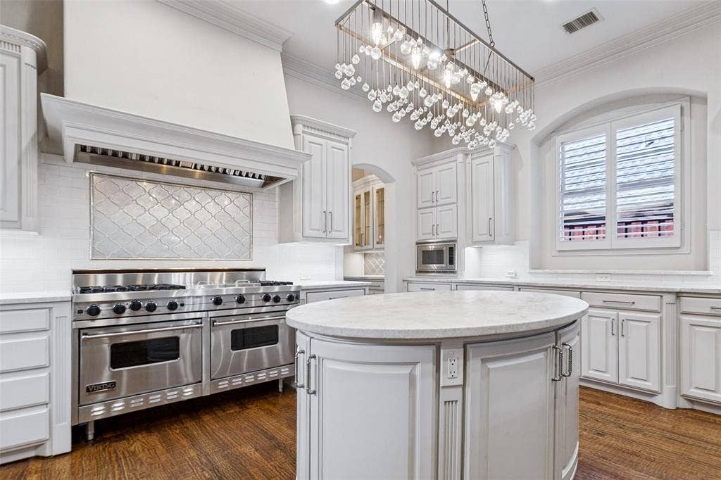 6467 Orchid Lane, Dallas, TX 75230 Every chef's dream - a 60 inch Viking Gas Range! The center task island offers electrical outlets and great storage. Microwave and butler's pantry are beyond. The large window brings the light in!