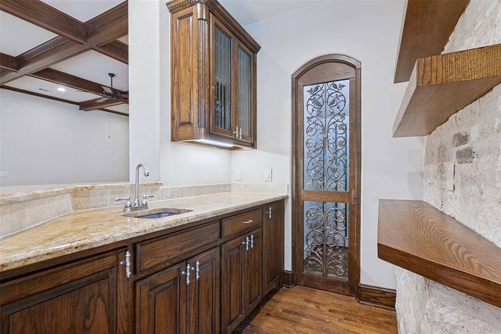 6467 Orchid Lane, Dallas, TX 75230 Wet Bar in the Family Room. More wine storage is behind the exquisite wood and iron door.