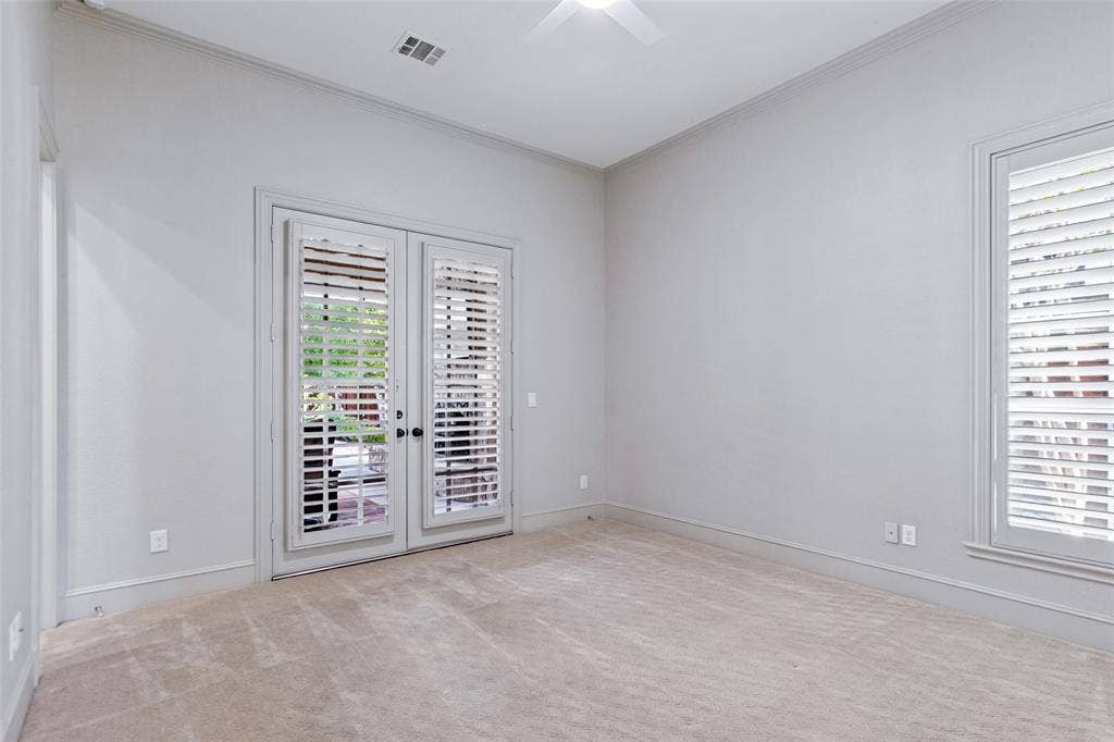6467 Orchid Lane, Dallas, TX 75230 An additional downstairs bedroom and bath is on the other side of the house. French doors lead to the outdoor living area.