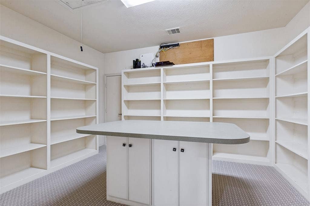 6467 Orchid Lane, Dallas, TX 75230 The Craft Room offers endless storage and a task iron for gift wrapping or projects!