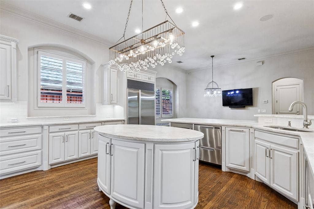 6467 Orchid Lane, Dallas, TX 75230 Gorgeous Taj Mahal counters and top-of-the-line appliances accent the Kitchen, including Bosch dishwasher, Bosch warming drawer, Fisher & Paykel dish drawers, Sub-Zero refrigerator/freezer, and Sub-Zero wine chiller.