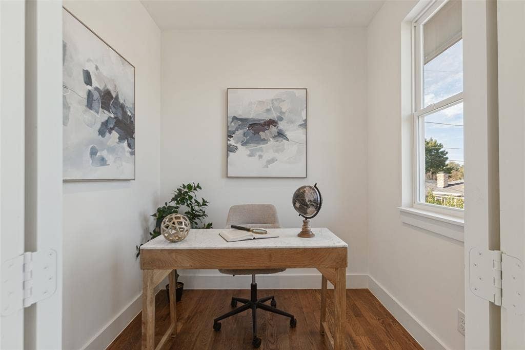 304 S Weatherred Drive, Richardson, TX 75080 Enclosed room featuring wood-finish flooring, white walls, and a large window