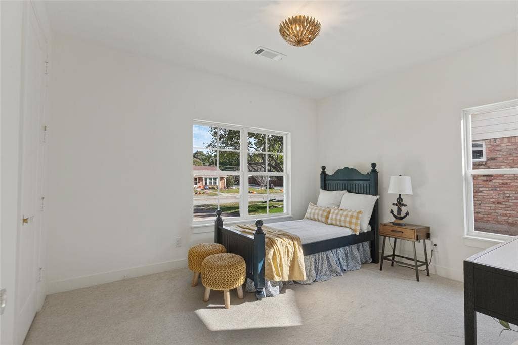 304 S Weatherred Drive, Richardson, TX 75080 Neutral-toned wall finish, wall-to-wall carpeting, multi-pane windows, and a decorative flush-mount ceiling light fixture