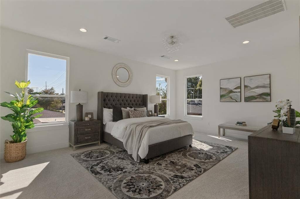 304 S Weatherred Drive, Richardson, TX 75080 Neutral-toned carpeted flooring, recessed lighting, neutral wall paint, and multiple windows providing natural light