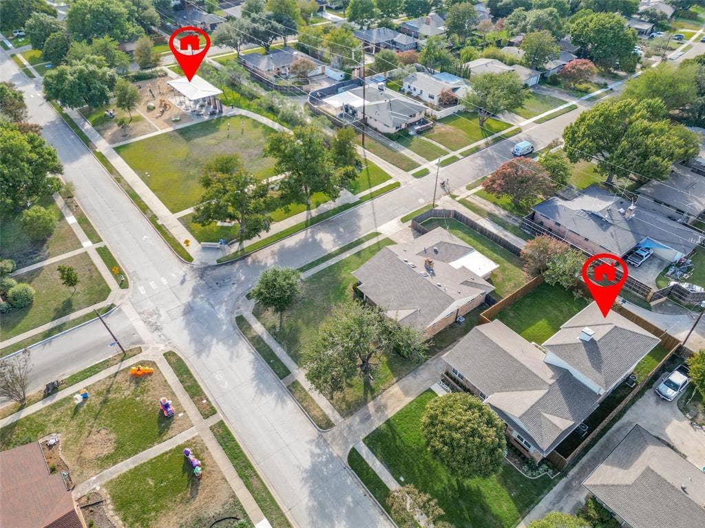 304 S Weatherred Drive, Richardson, TX 75080 Aerial perspective showcasing a corner lot property featuring a composition shingle roof, chimney, and proximity to public greenspace