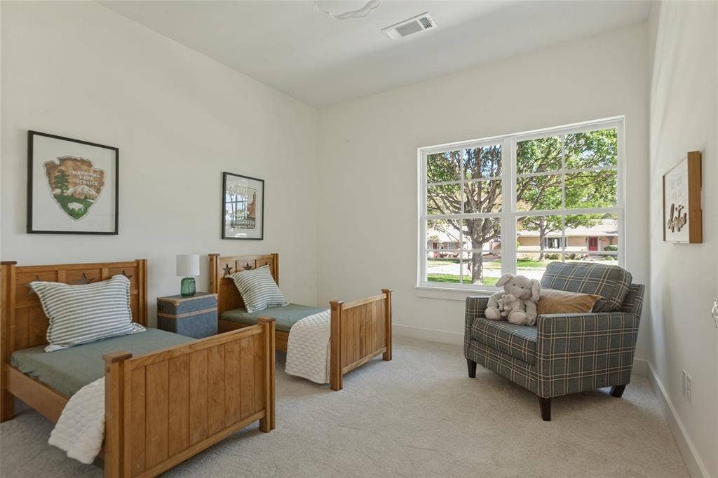 304 S Weatherred Drive, Richardson, TX 75080 Neutral interior space featuring high ceilings, wall-to-wall carpeting, and a large multi-pane window with exterior greenery