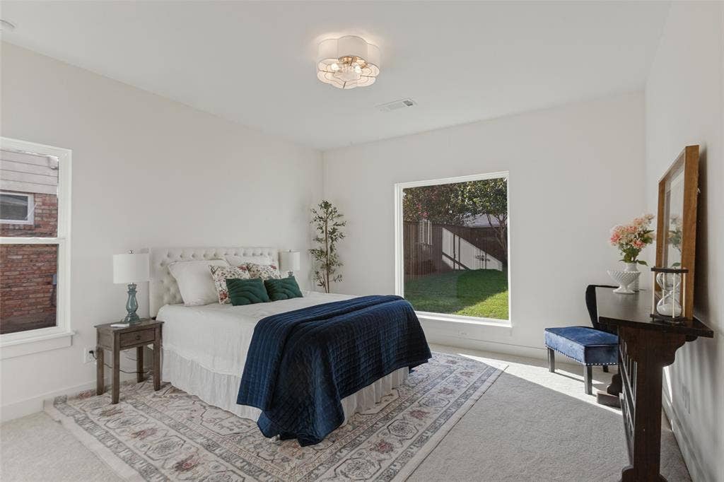 304 S Weatherred Drive, Richardson, TX 75080 Neutral-toned room featuring expansive windows, neutral wall-to-wall carpeting, and a multi-bulb flush-mount ceiling fixture