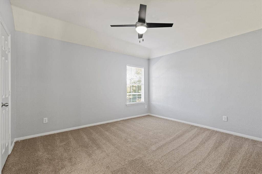 892 Brentwood Drive, Coppell, TX 75019 Neutral-toned interior featuring high ceilings, wall-to-wall carpeting, and a modern ceiling fan with integrated lighting