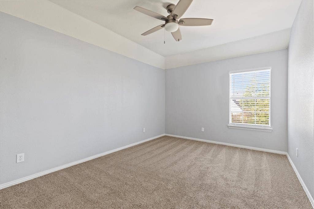 892 Brentwood Drive, Coppell, TX 75019 Room featuring neutral carpeting, a tray ceiling, and a five-blade ceiling fan with a central light fixture