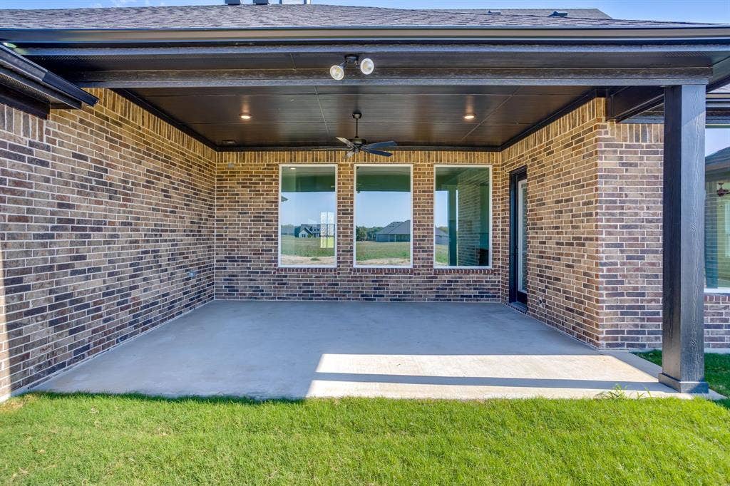501 Olson Road, Waxahachie, TX 75167 Covered brick patio featuring a concrete floor, recessed ceiling lighting, a built-in ceiling fan, and large rectangular windows