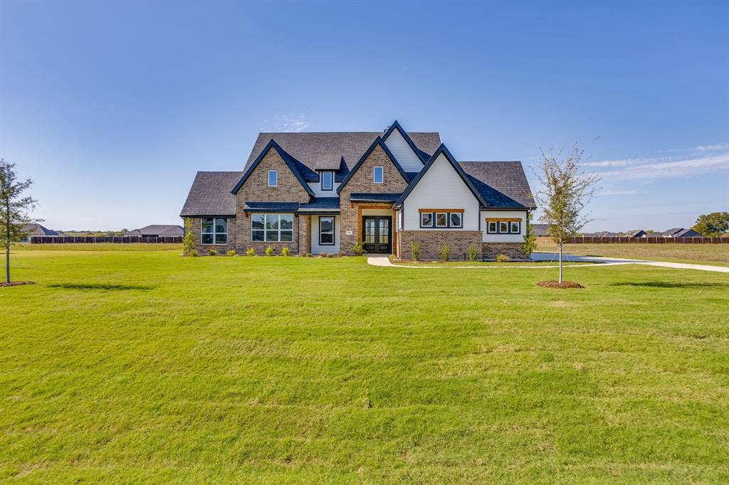 501 Olson Road, Waxahachie, TX 75167 Multi-gabled exterior featuring brick and siding facade, steep rooflines, multi-pane windows, and a concrete pathway leading to the main entrance