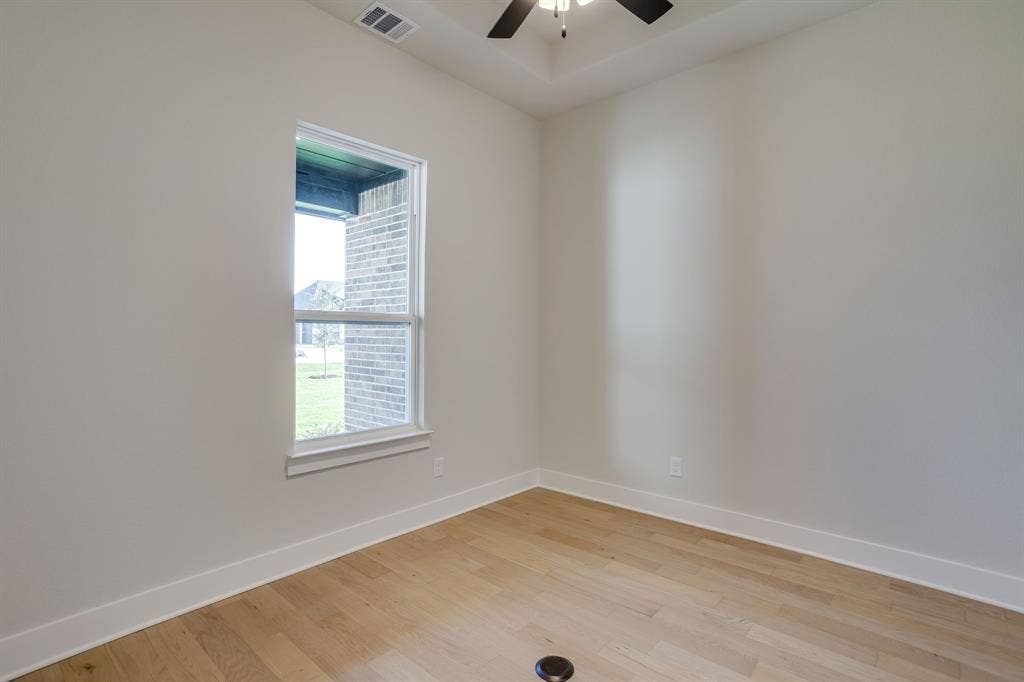 501 Olson Road, Waxahachie, TX 75167 Interior space featuring wood-finish flooring, a coffered ceiling, and a ceiling fan with integrated lighting
