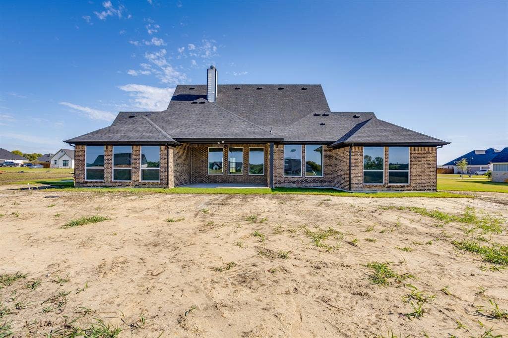 501 Olson Road, Waxahachie, TX 75167 Multi-gabled exterior featuring brick masonry, large pane windows, a covered patio, and a chimney