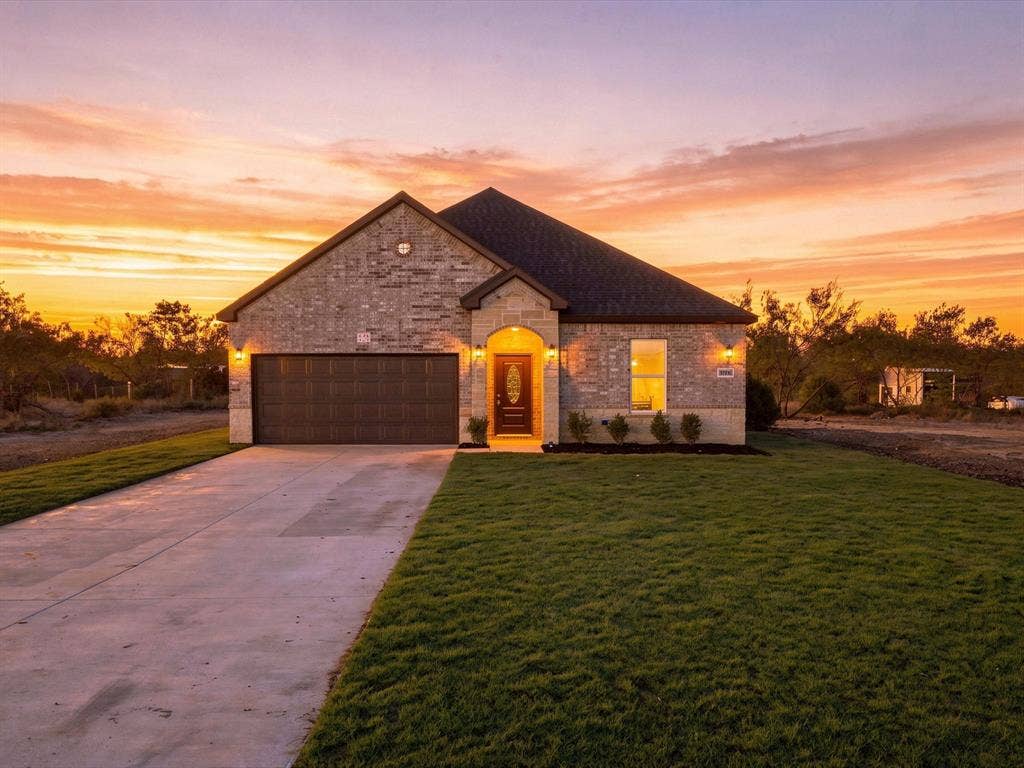 5365 Rabbit Trail, Kemp, TX 75143 Single-story residence featuring a brick exterior, a covered entryway, a two-car garage, and an expansive front lawn