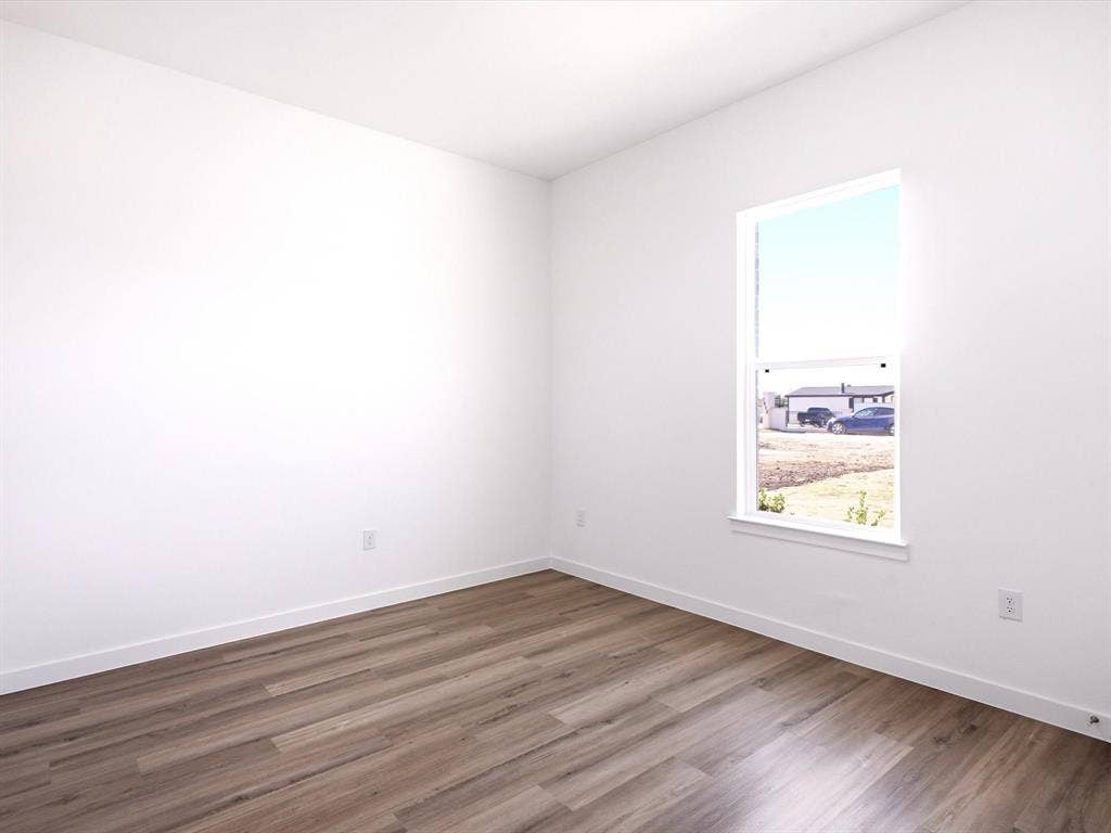 5365 Rabbit Trail, Kemp, TX 75143 Neutral interior room featuring wood-finish flooring, white walls, and a single-hung window with a sill