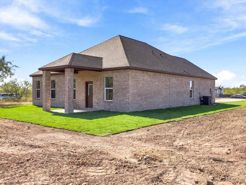 5365 Rabbit Trail, Kemp, TX 75143 Brick exterior featuring a hip roof, covered rear porch with masonry pillars, and rectangular windows