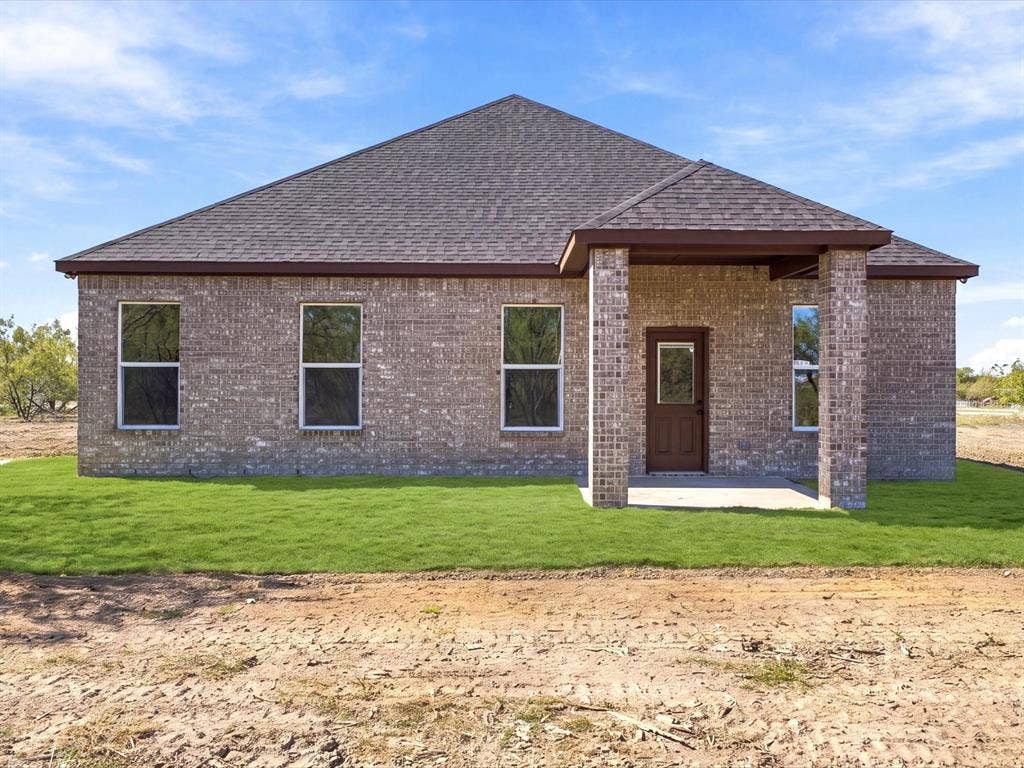 5365 Rabbit Trail, Kemp, TX 75143 Single-story brick exterior featuring a multi-pitched shingle roof, covered entryway with stone-accented pillars, and vertical-sliding windows