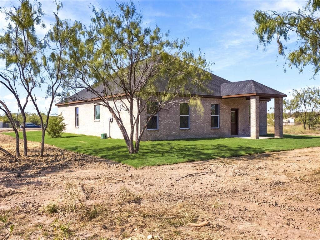 5365 Rabbit Trail, Kemp, TX 75143 Exterior featuring light brick masonry, a covered patio with brick columns, and a hipped roofline